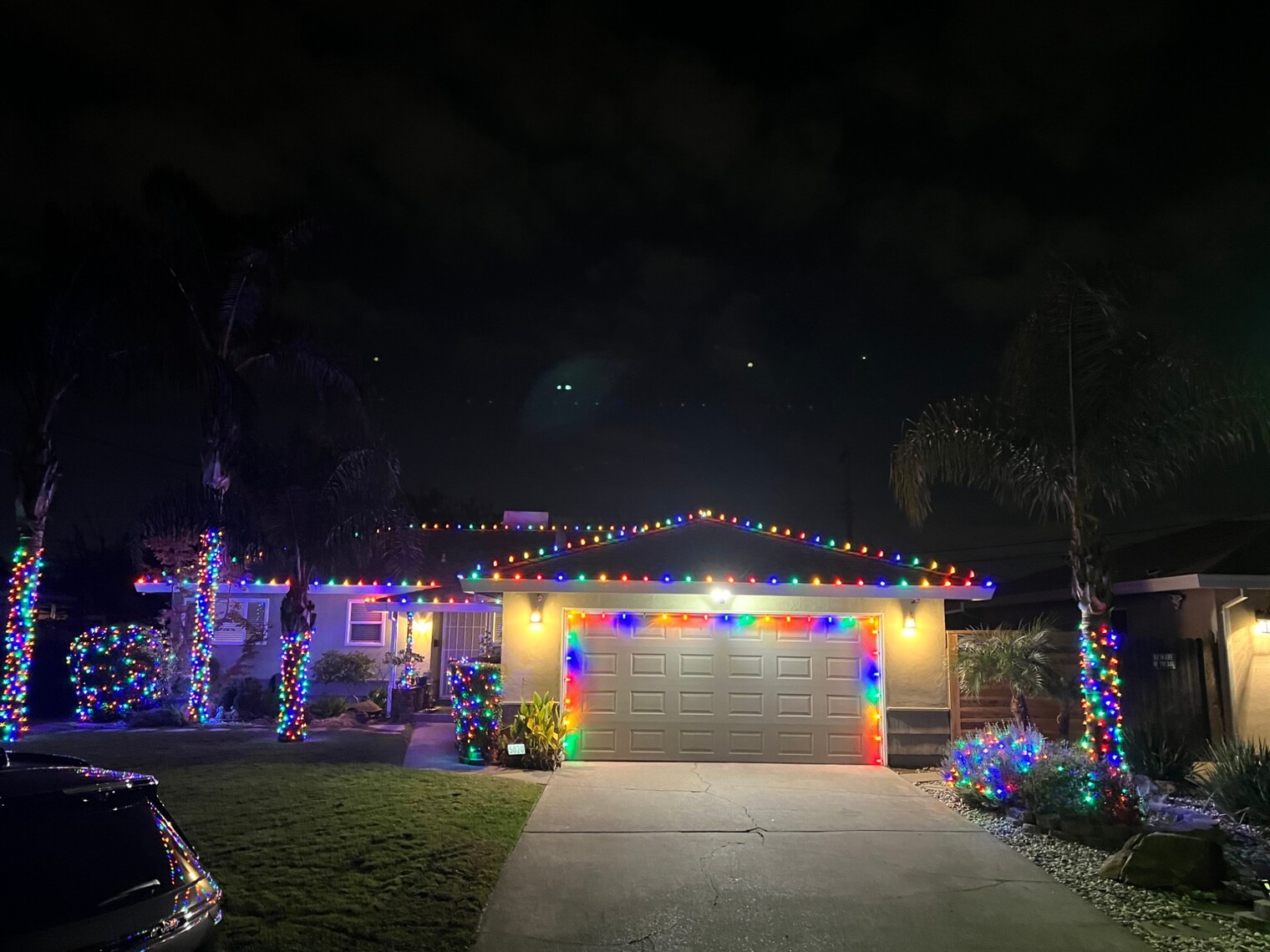 Christmas light service in Roseville, CA: ranch multicolor roofline garage outline palm wraps